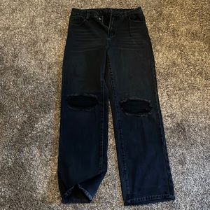 Black jeans with rips in the knees